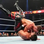 Abyss wrestler Christopher Park delivering a choke slam in an electrifying wrestling match, showcasing his power and height.